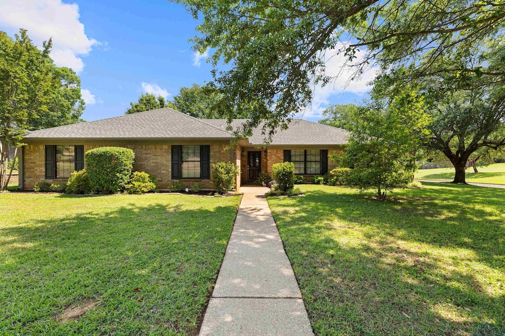 Single story home with brick siding, roof with shi