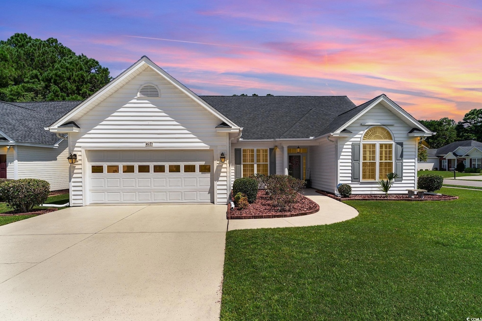Single story home featuring a garage and a yard