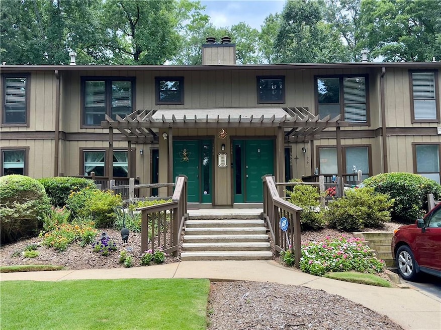 View of front of property with a pergola and a chimney