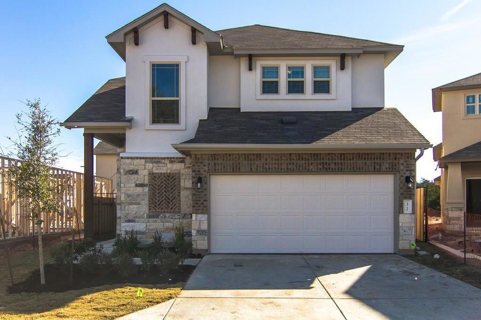 View of front of home with stucco siding, stone s