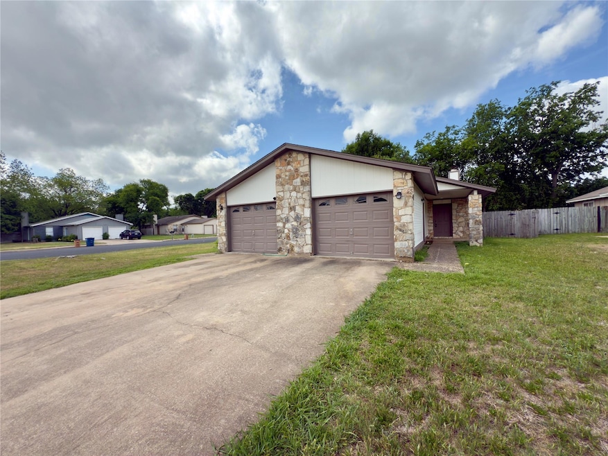View of front of property featuring driveway, sto