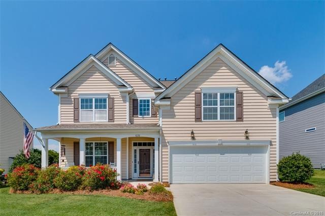 Two Story Home with Front Porch and Tandem 3 Car G
