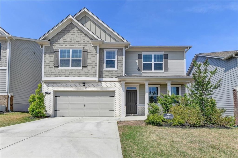Craftsman-style home with a front yard and a garage