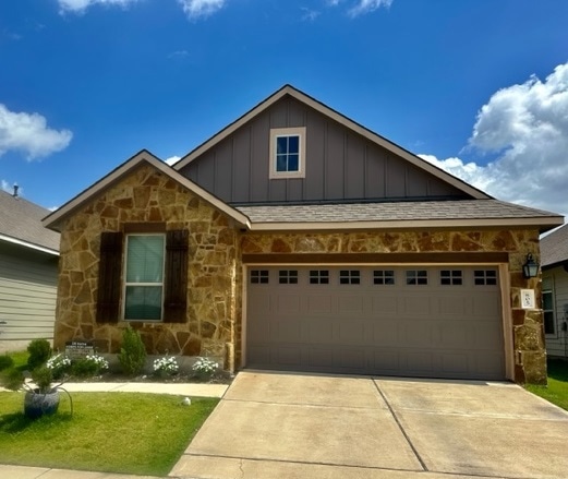 View of front facade with board and batten siding,