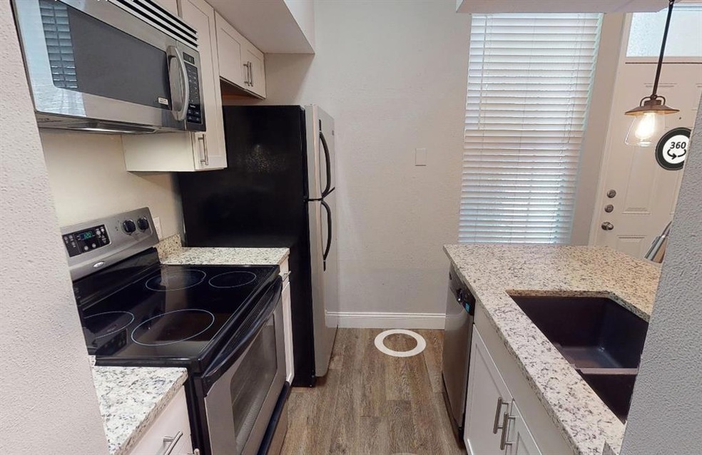 Kitchen featuring stainless steel appliances, lig