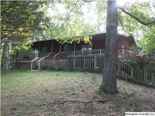 RUSTIC CEDAR HOME SURROUNDED WITH APPR. 12 ACRES O