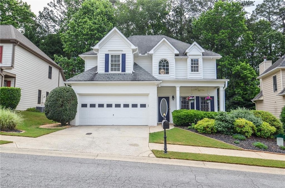 Traditional home featuring driveway, a garage, a s