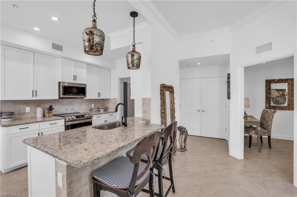 Kitchen featuring decorative light fixtures, stain