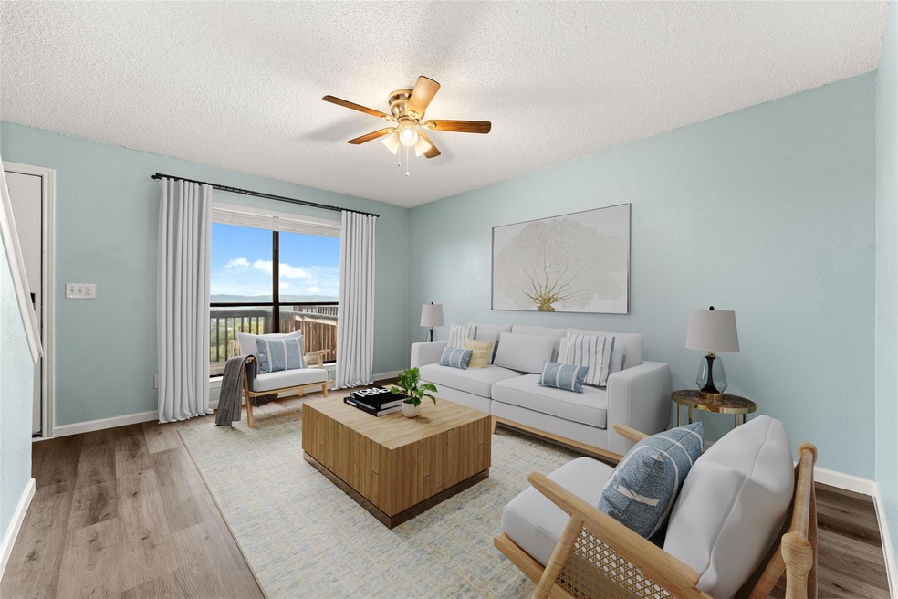 Living room featuring ceiling fan, light wood-typ