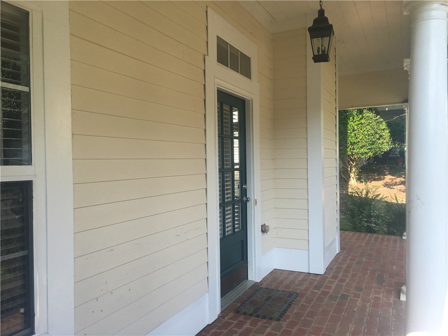 Brick floor at front porch!  Inviting glassed fron