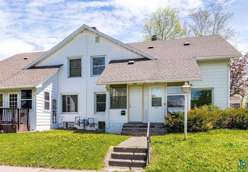 View of front of property featuring a front lawn, roof with shingles, entry steps, and central AC unit