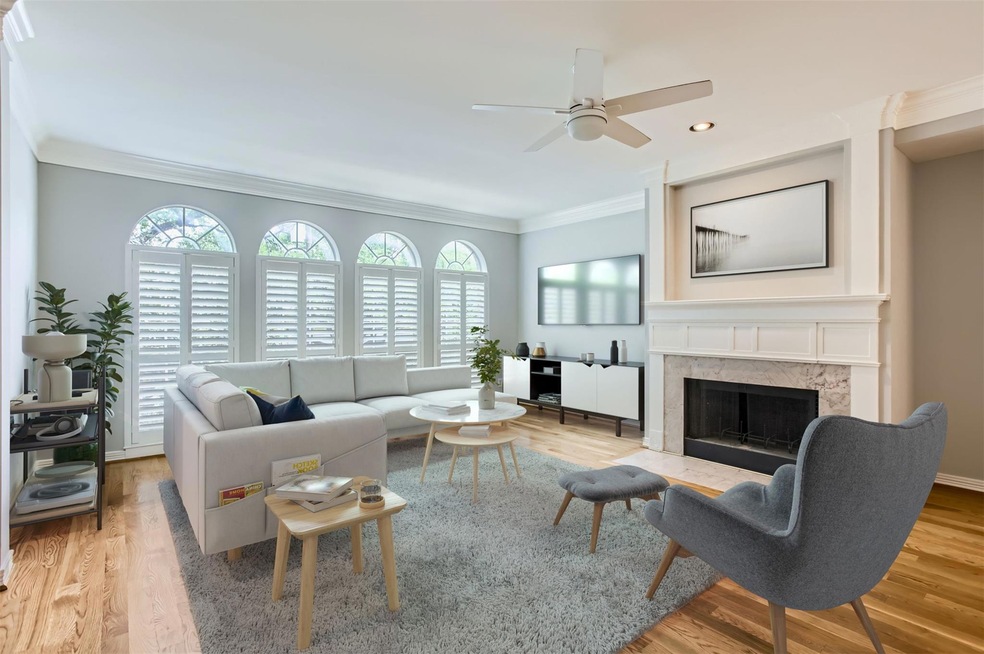 Living room with wood finished floors, ceiling fa