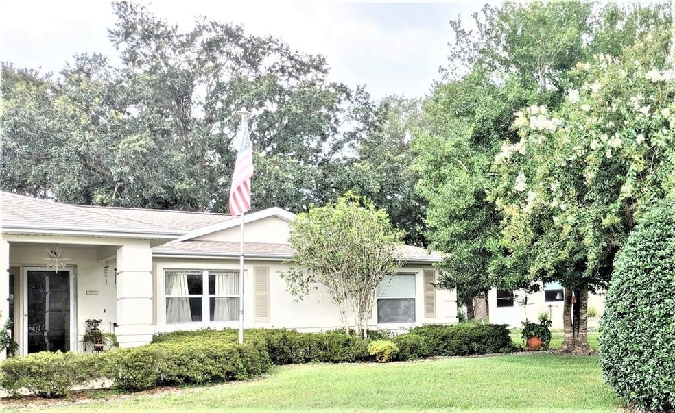 Front of home with mature landscaping