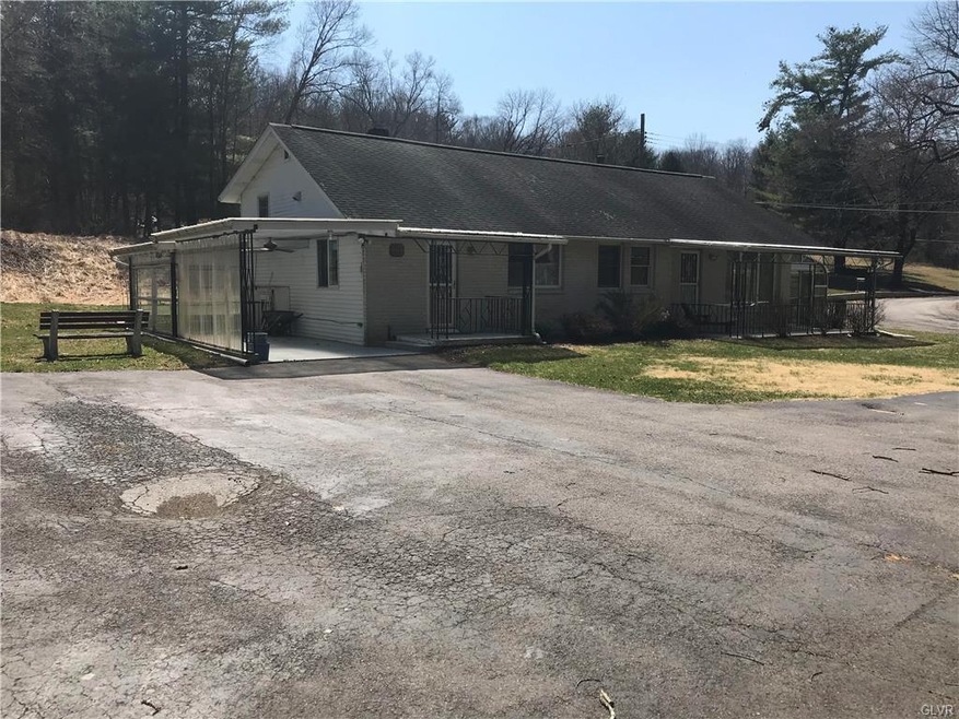 View of house with ample parking area