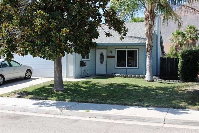 Front view of the home with large magnolia for sha