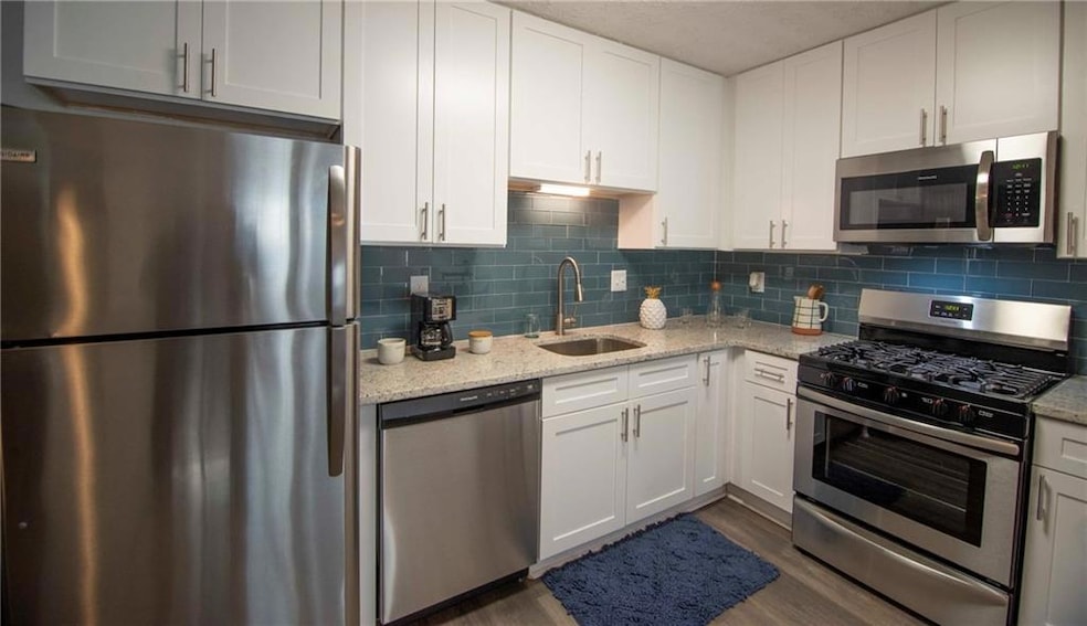 Kitchen featuring stainless steel appliances, whit
