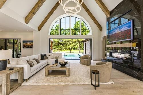 Living room featuring high vaulted ceiling, a nota