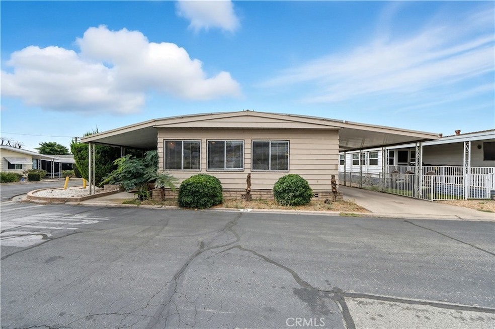 Front Corner with Enclosed Patio and Carport Parking