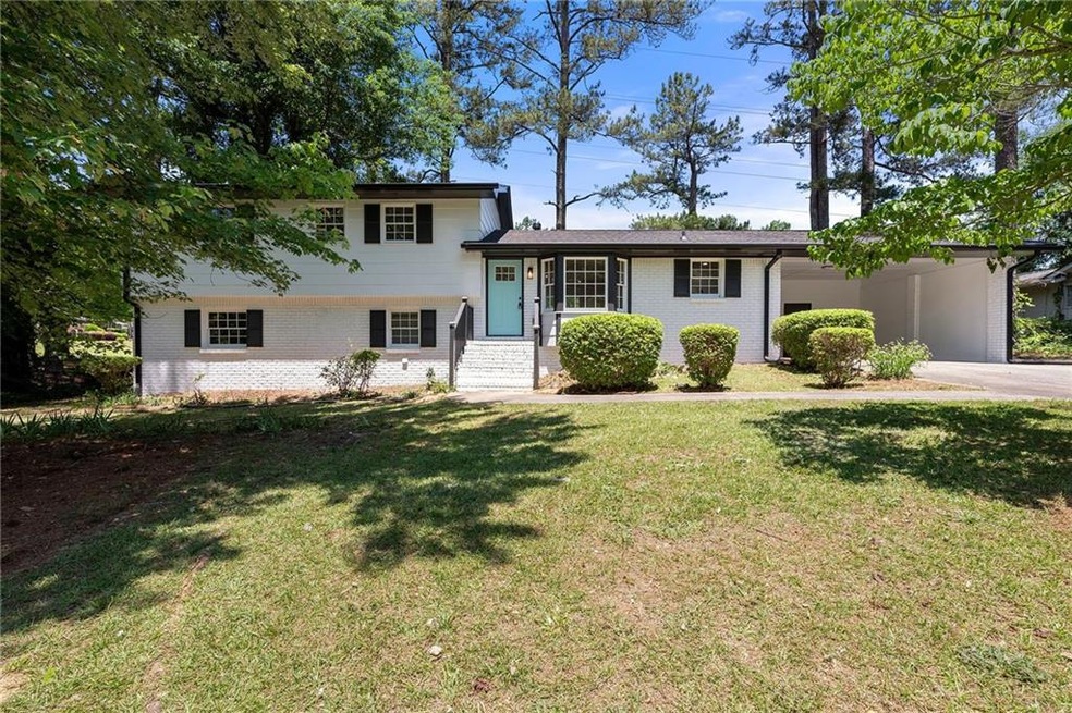 Tri-level home featuring a front lawn