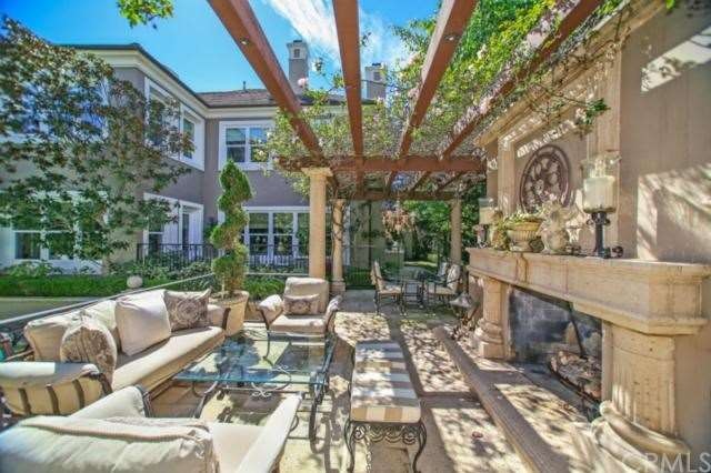 Outdoor living space in backyard with custom firep