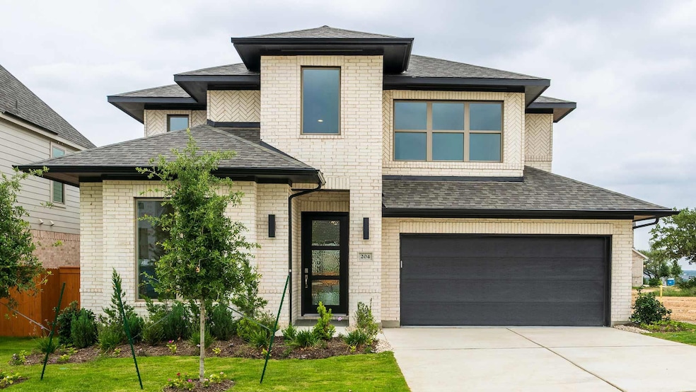 Prairie-style home featuring brick siding, a shin