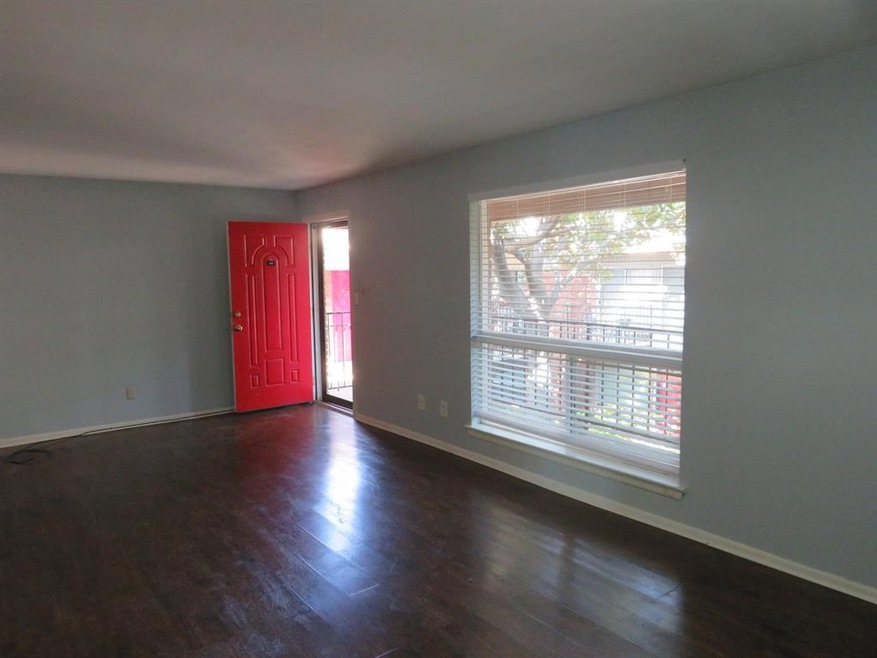 Living room with storm door and large window with 