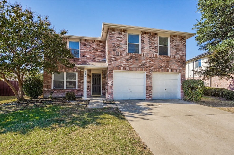 Traditional home with brick siding, concrete driveway, and a garage