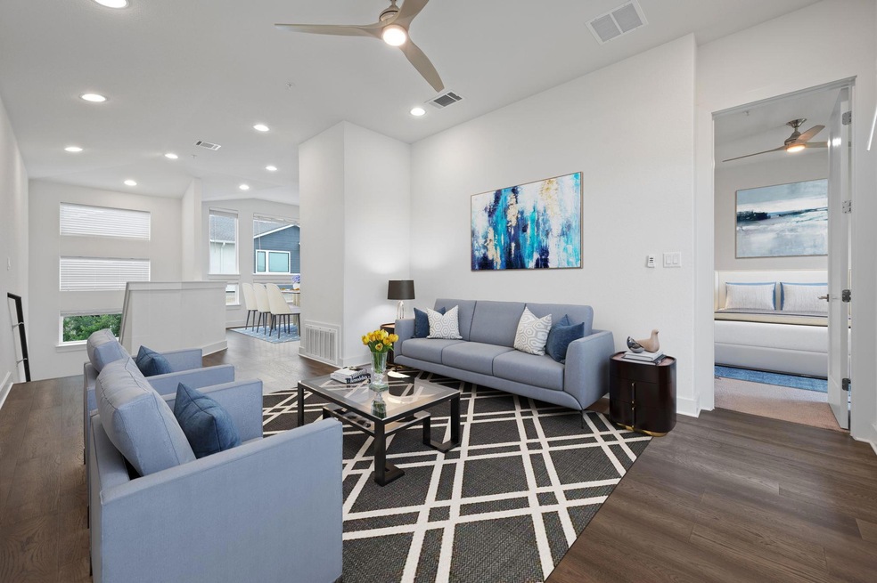 Living area featuring ceiling fan, wood finished 