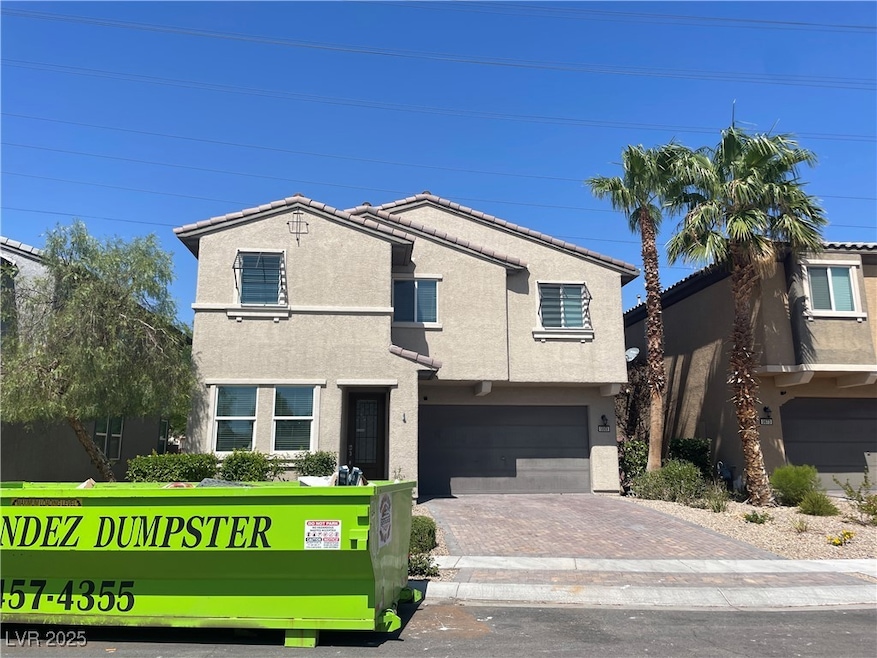 View of front of house with decorative driveway, s