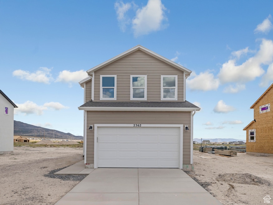Traditional-style house featuring a mountain view, driveway, and a garage
