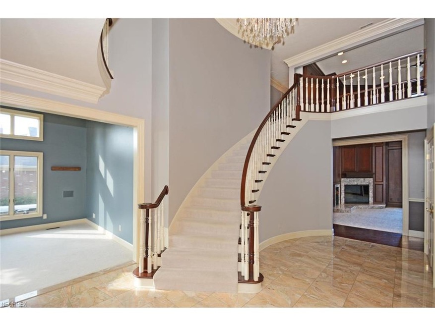 Two story entry welcomes you with marble floors and curving stairway