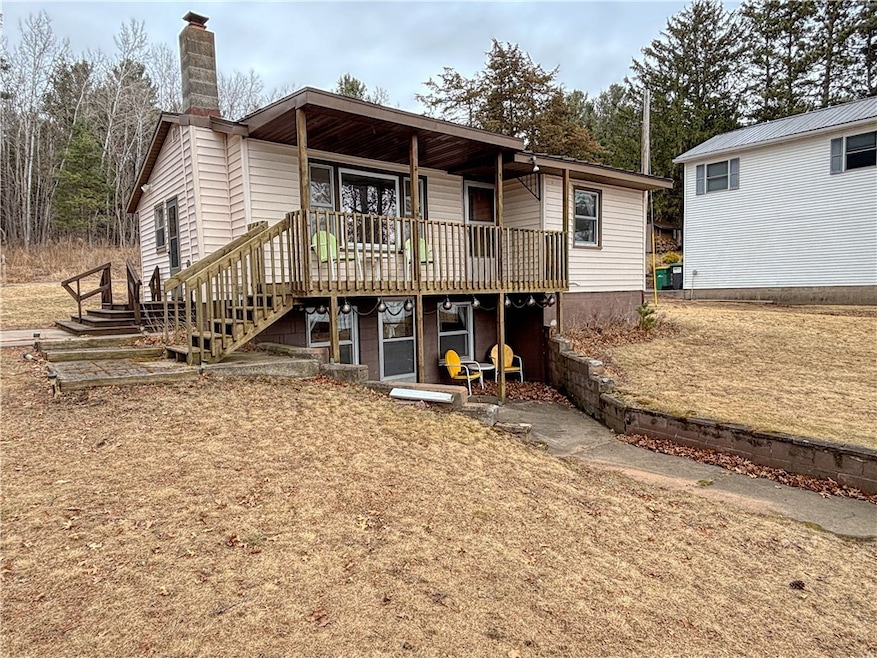 Front of home with covered deck and walkout lakesi