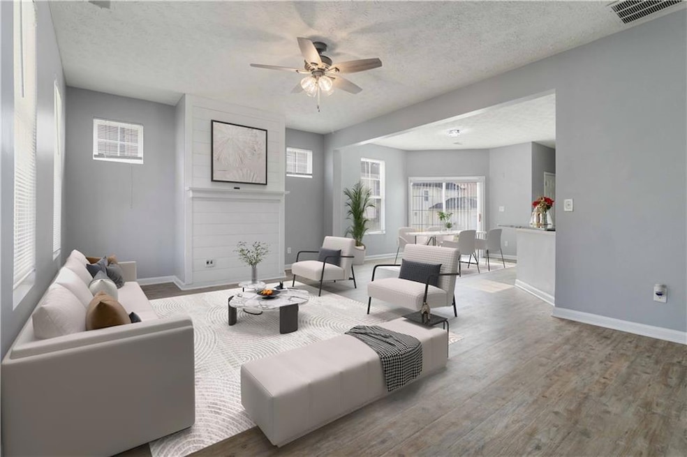 Living room with visible vents, baseboards, ceilin