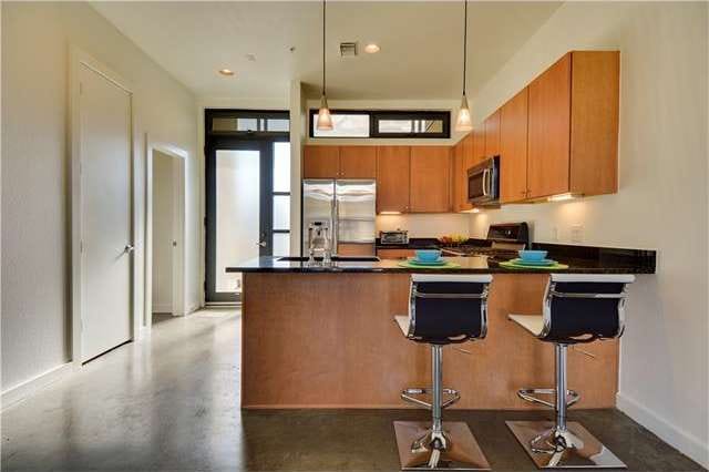 Entrance door to lovely condo, with designer light