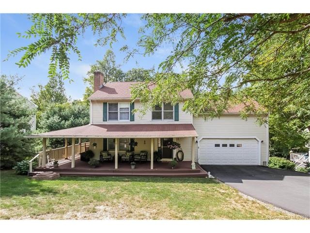 Expansive wrap around mahogany porch with new driv