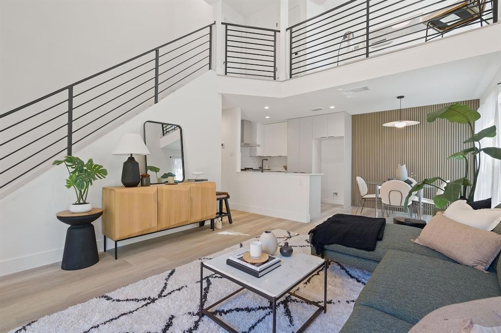 Living room featuring baseboards, light wood-styl