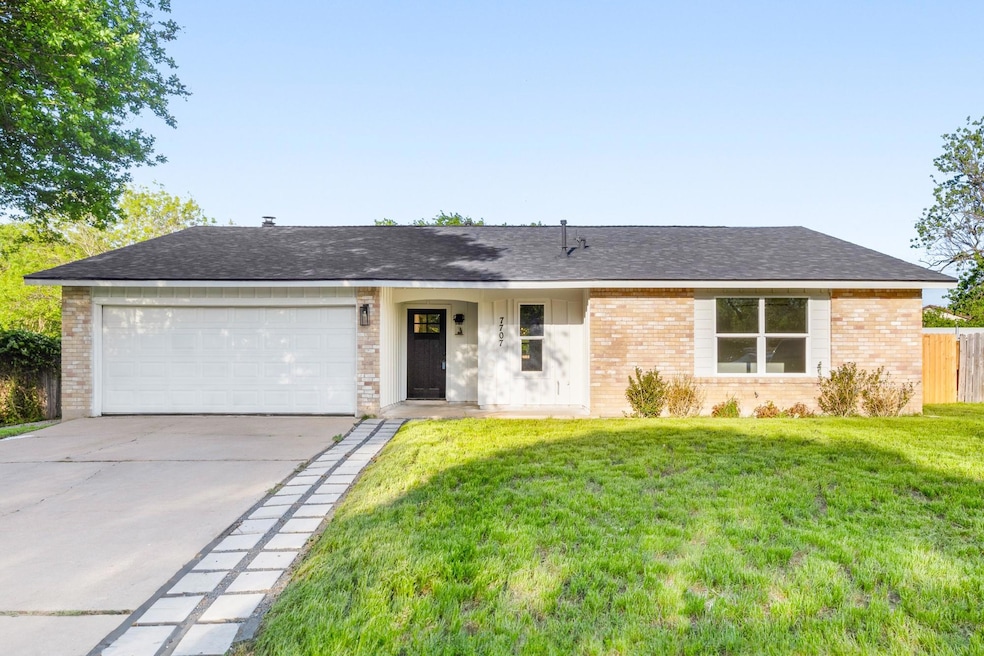 Ranch-style house with a garage, a front yard, br