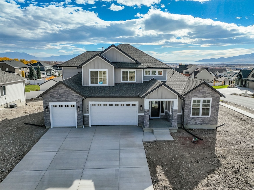 Craftsman house featuring board and batten siding, a shingled roof, a mountain view, and concrete driveway