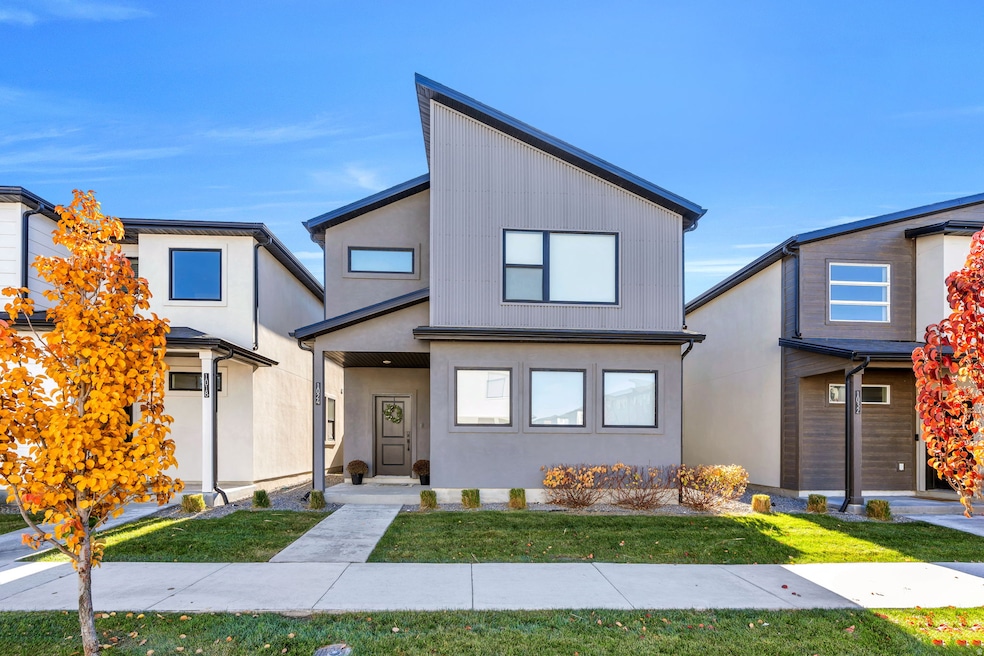 View of front of house with a front lawn and stucco siding