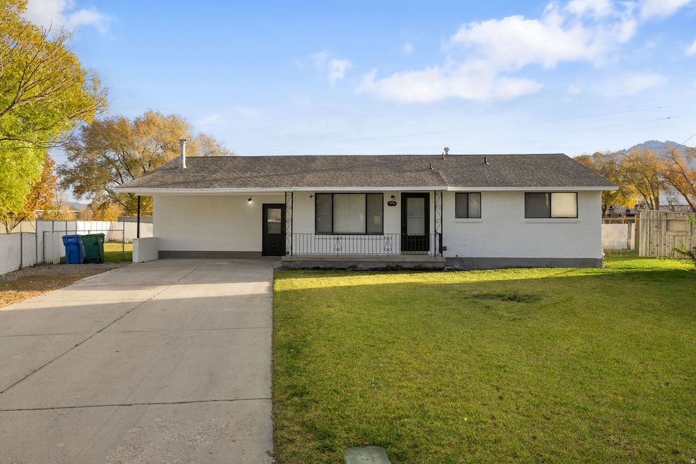 Ranch-style house with a porch, brick siding, roof with shingles, and concrete driveway