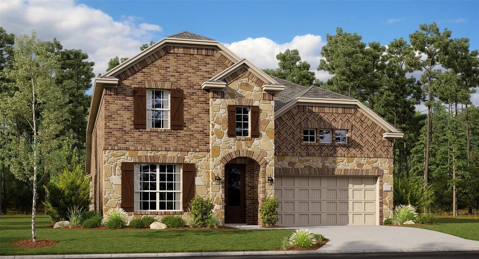 View of front of house with a garage and a front y