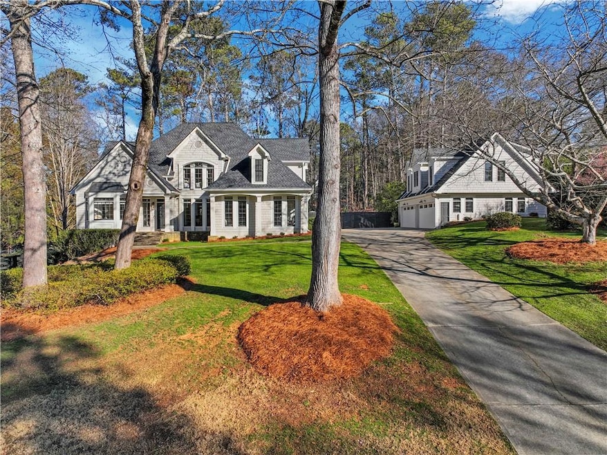 Traditional house with a front yard and a carriage house.