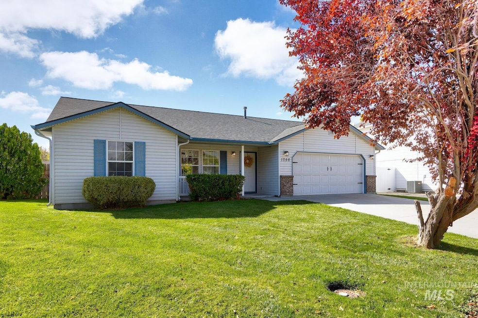 Single story home featuring a front yard, driveway, a garage, brick siding, and a porch
