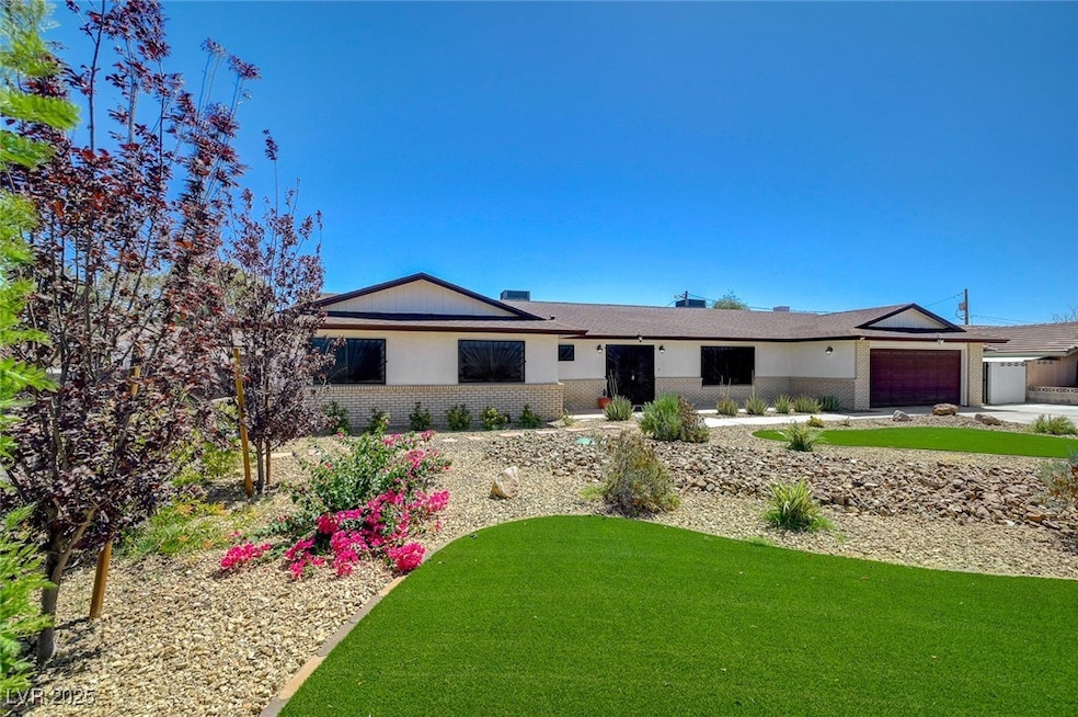 Ranch-style home with a garage and brick siding