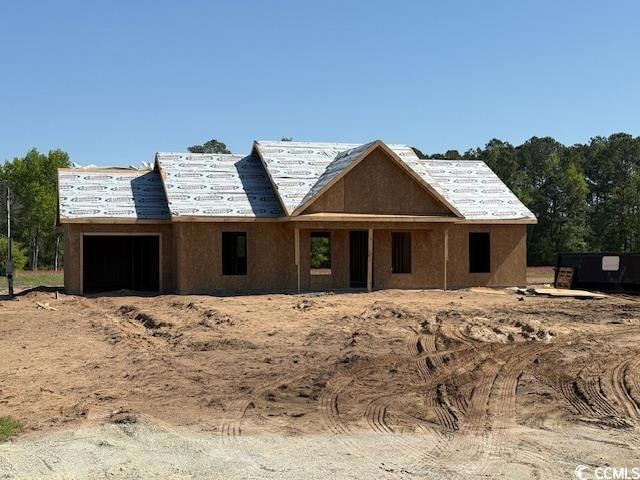 Property under construction featuring a garage