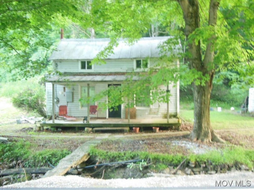 Front view of house with a small stream between th