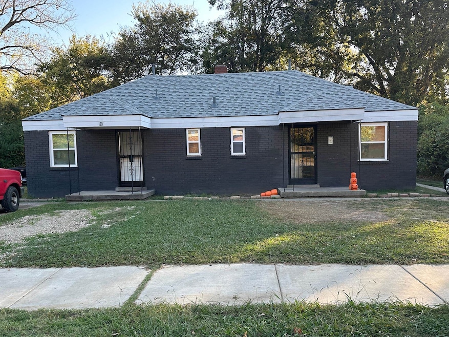 View of front of home with a front yard and covere