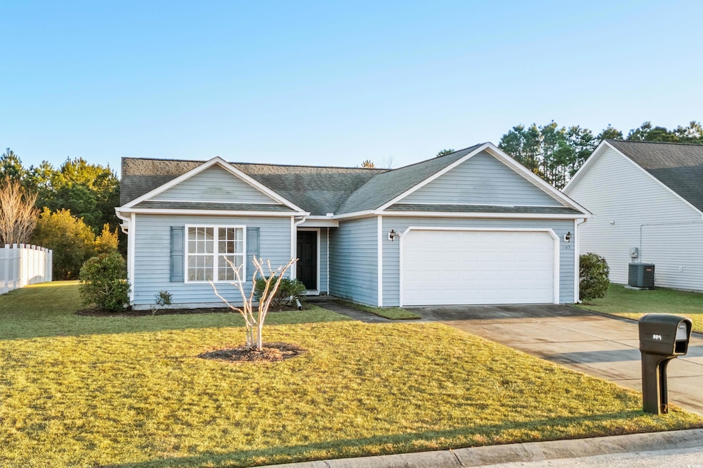 Ranch-style home with a front yard, a garage, and 