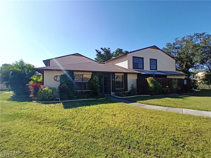 View of front of property with a front lawn, a sun