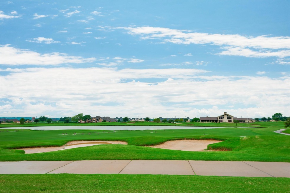 View of home's community featuring view of golf course and a lawn